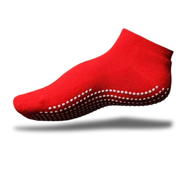 A red GripSox non-slip ankle sock with a textured rubber sole for improved grip.