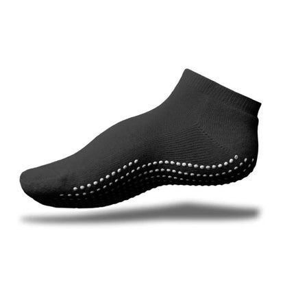 A black GripSox non-slip ankle sock with a textured rubber sole for improved grip.